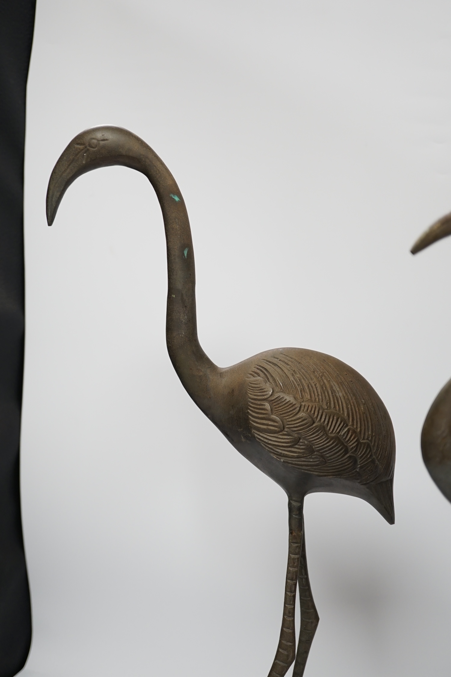 A pair of brass cranes, a pair of brass chamber sticks another chamberstick and a bowl, tallest 53cm high